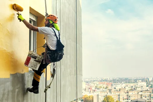 Rope-access painting on a high wall in Thousand Oaks