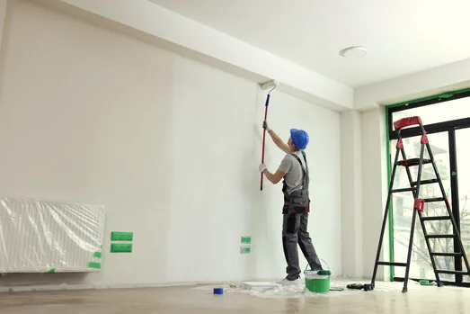Painter rolling a bright office wall in a Westlake Village office park